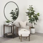 Round wall mirror with slim metal frame.