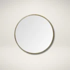 Round wall mirror with slim metal frame.