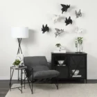 Black metal accent cabinet with glass double doors featuring crisscross design and interior shelving.