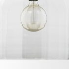 Clear glass dome pendant light with brass accents and exposed bulb.