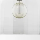 Clear glass dome pendant light with brass accents and exposed bulb.