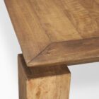 Rectangular solid wood dining table with angled apron detail and block legs in a warm golden-brown finish.
