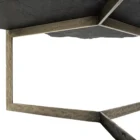 Irregular black stone coffee table with a jagged, organic edge and industrial hammered metal base.