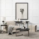 Irregular black stone coffee table with a jagged, organic edge and industrial hammered metal base.