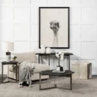 Irregular black stone coffee table with a jagged, organic edge and industrial hammered metal base.