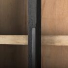 A tall arched black wood cabinet with open shelving and a black metal frame, featuring natural wood interior and closed bottom doors.