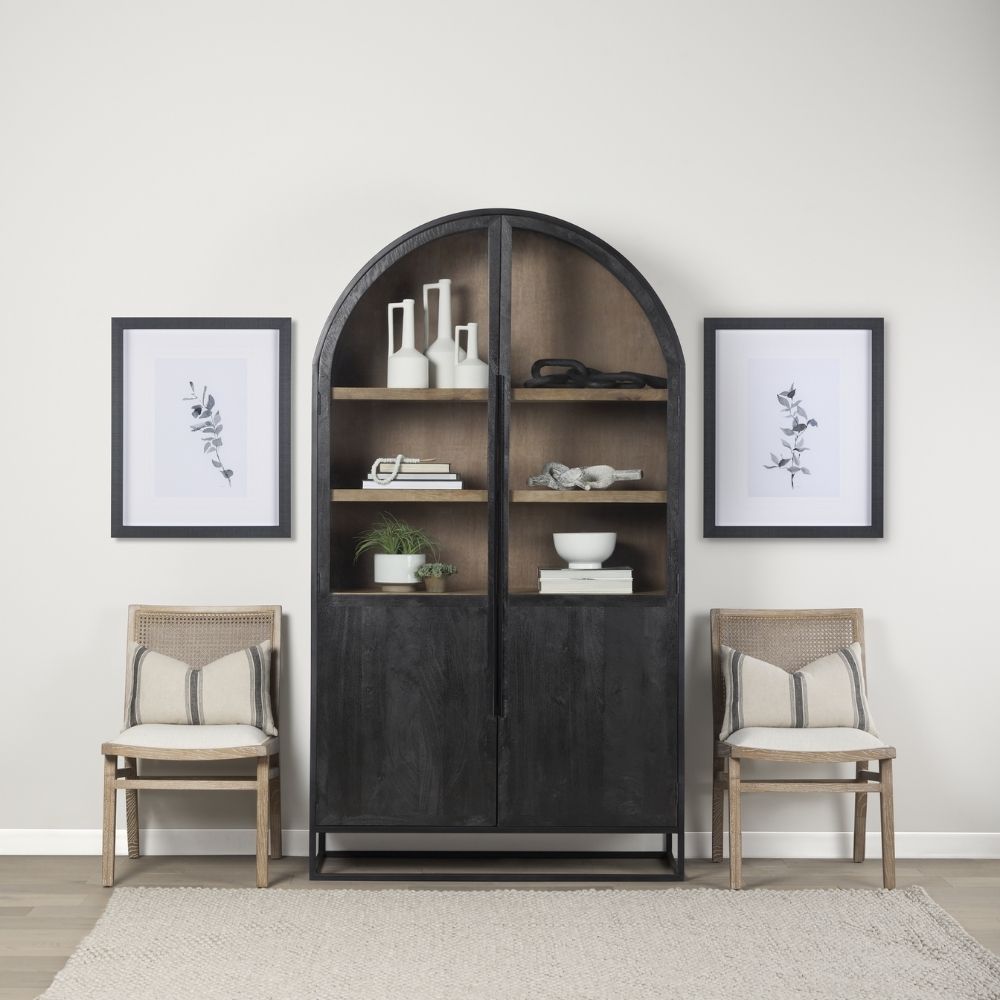 A tall arched black wood cabinet with open shelving and a black metal frame, featuring natural wood interior and closed bottom doors.