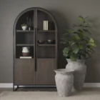 Tall arched cabinet in dark brown wood with black metal frame and glass panel doors – Mercana Sloan Cabinet