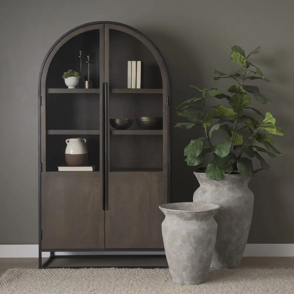 Tall arched cabinet in dark brown wood with black metal frame and glass panel doors – Mercana Sloan Cabinet