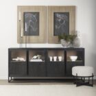 Black wood and metal-framed sideboard with four glass-front cabinets and natural wood interior.