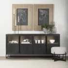 Black wood and metal-framed sideboard with four glass-front cabinets and natural wood interior.