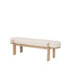 Light oak bench with rounded upholstered cushion in soft neutral fabric.