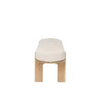 Light oak bench with rounded upholstered cushion in soft neutral fabric.
