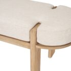 Light oak bench with rounded upholstered cushion in soft neutral fabric.