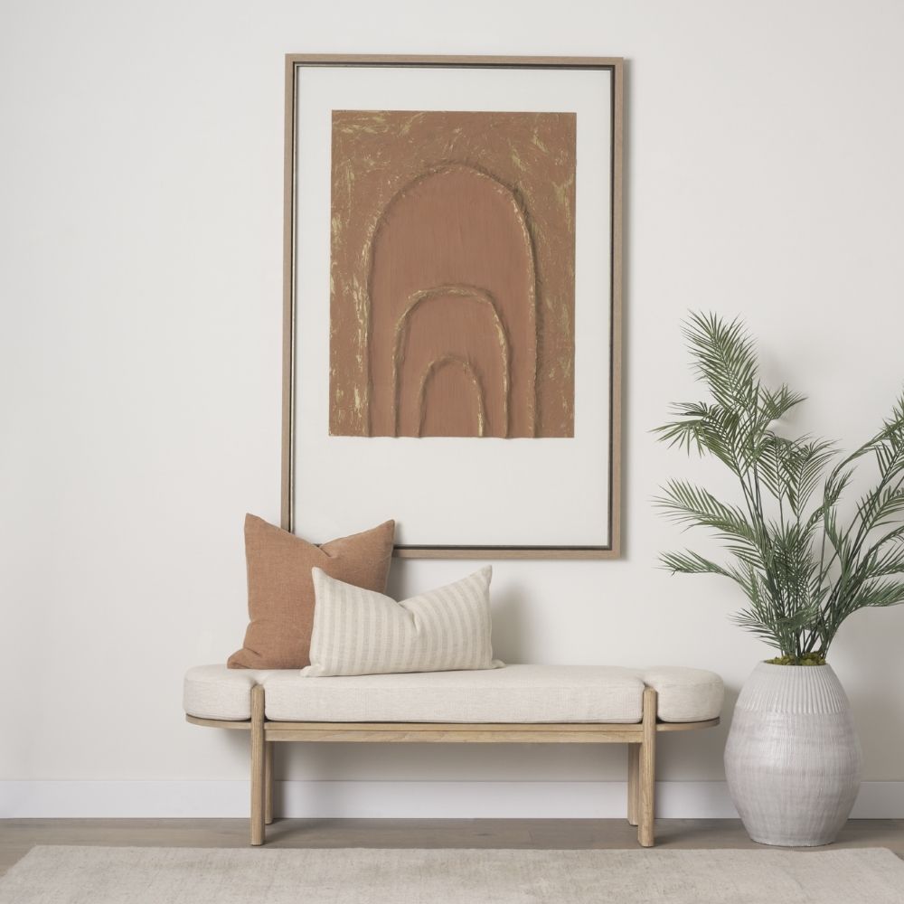 Light oak bench with rounded upholstered cushion in soft neutral fabric.