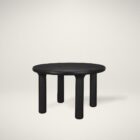 Round black solid wood accent table with chunky legs and sculptural design – Mercana Soma Table.