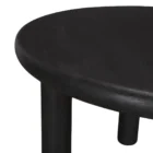 Round black solid wood accent table with chunky legs and sculptural design – Mercana Soma Table.