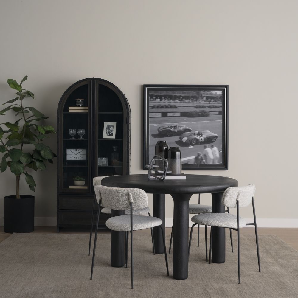 Round black solid wood accent table with chunky legs and sculptural design – Mercana Soma Table.