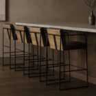 Black leather and metal frame bar stool with minimalist silhouette and slim profile.