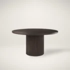 Round dark wood dining table with fluted cylindrical pedestal base.