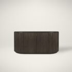 Dark fluted wood sideboard with rounded corners and brass handles.