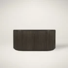 Dark fluted wood sideboard with rounded corners and brass handles.
