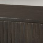 Dark fluted wood sideboard with rounded corners and brass handles.