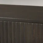 Dark fluted wood sideboard with rounded corners and brass handles.