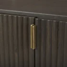 Dark fluted wood sideboard with rounded corners and brass handles.