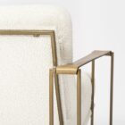 Mercana Watson accent chair featuring a modern metal frame with white boucle upholstery and wood armrests.