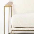 Mercana Watson accent chair featuring a modern metal frame with white boucle upholstery and wood armrests.
