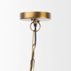 Mercana Willson pendant light featuring a matte black dome shade and sculptural antique gold spindle stem.