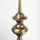Mercana Willson pendant light featuring a matte black dome shade and sculptural antique gold spindle stem.