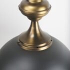 Mercana Willson pendant light featuring a matte black dome shade and sculptural antique gold spindle stem.