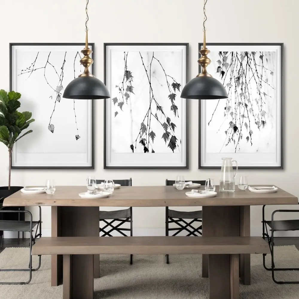Mercana Willson pendant light featuring a matte black dome shade and sculptural antique gold spindle stem.