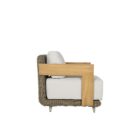 Outdoor lounge chair with white cushions, woven wicker frame, and teak wood arms.