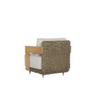 Outdoor lounge chair with white cushions, woven wicker frame, and teak wood arms.