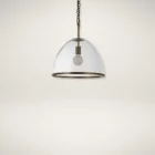 Glass dome pendant light with antique brass accents and exposed bulb, suspended by a matching brass chain.
