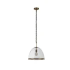 Glass dome pendant light with antique brass accents and exposed bulb, suspended by a matching brass chain.