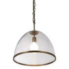 Glass dome pendant light with antique brass accents and exposed bulb, suspended by a matching brass chain.