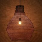Sculptural wire pendant light in a natural brass tone.