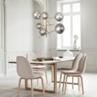 Modern gold chandelier with staggered rods and smoky mirrored glass globe shades