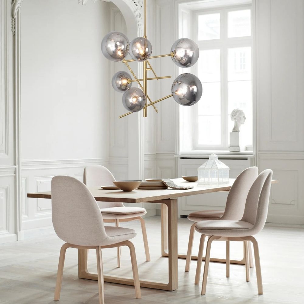 Modern gold chandelier with staggered rods and smoky mirrored glass globe shades