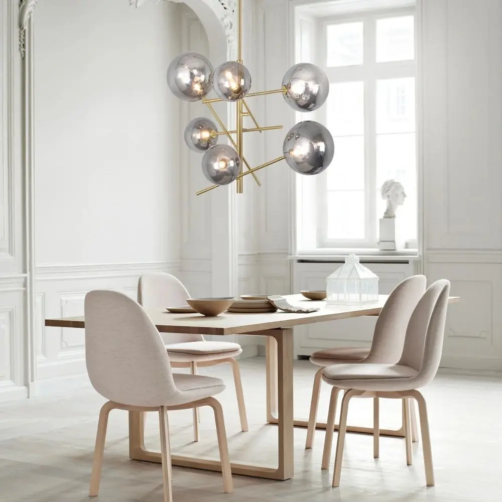 Modern gold chandelier with staggered rods and smoky mirrored glass globe shades