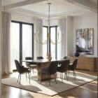 Brushed brass six-arm chandelier with curved arms and minimalist candelabra bulbs.