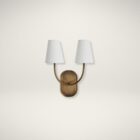 Double-arm wall sconce with antique brass finish and white fabric shades.