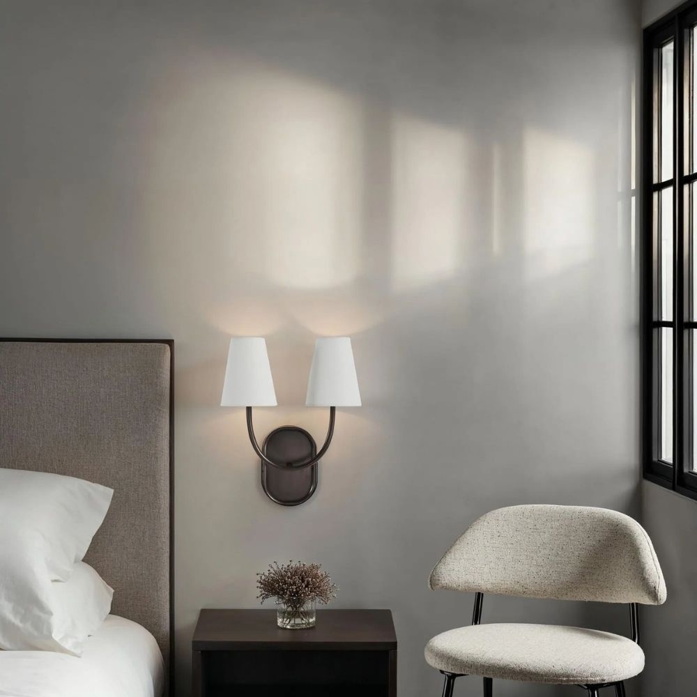 Double-arm wall sconce with white tapered shades and oil-rubbed bronze finish.