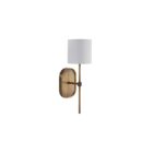 Brushed brass wall sconce with a white cylindrical fabric shade and elongated backplate.
