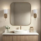 Brushed brass wall sconce with a white cylindrical fabric shade and elongated backplate.