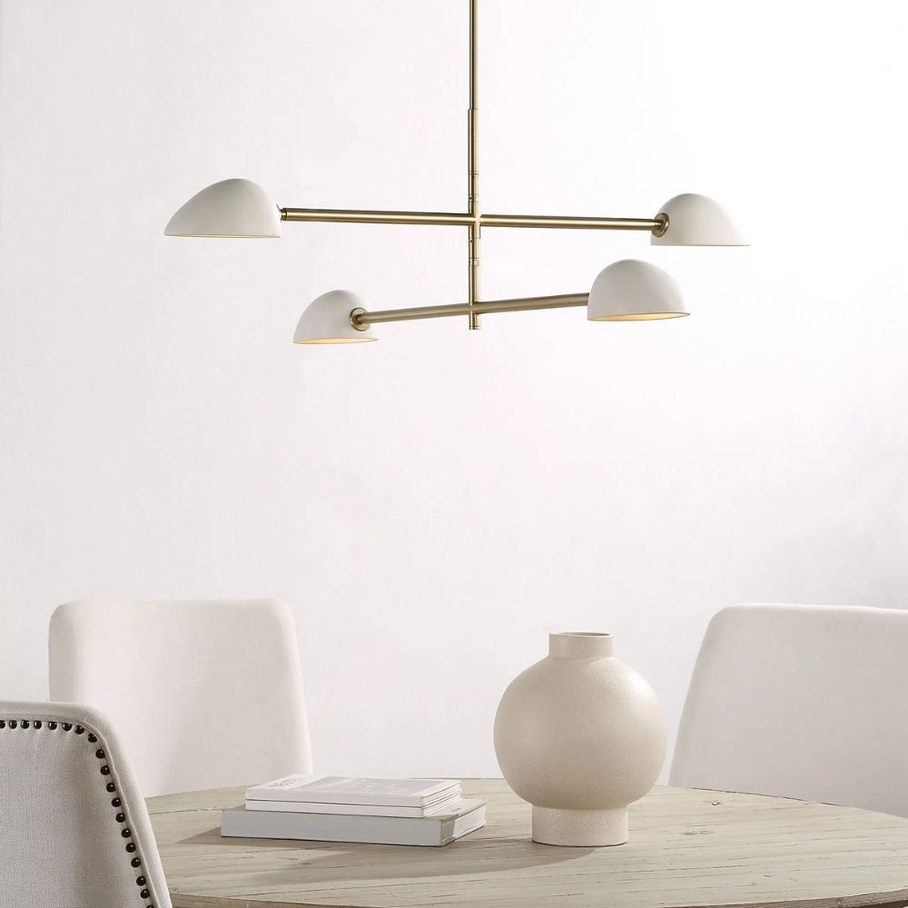 Modern brass chandelier with four angled white metal dome shades.